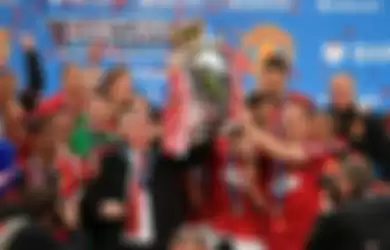 Manchester United manager Sir Alex Ferguson celebrates with the Premier League trophy