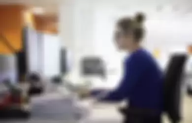 Young woman using computer in office