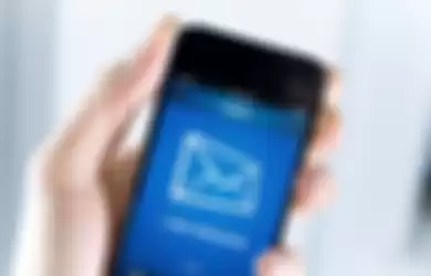 A man holding smartphone with one new message on a screen. Closeup shot.