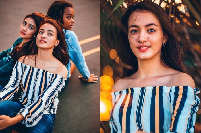 Mawar Eva dengan busana off shoulder bermotif stripe