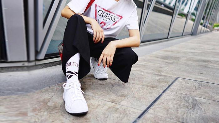 memakai sneakers