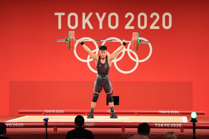 Atlet angkat besi Indonesia, Rahmat Erwin Abdullah, saat berlomba pada sesi Grup B nomor 73kg putra Olimpiade Tokyo 2020 di Tokyo International Forum, Jepang, 28 Juli 2021.