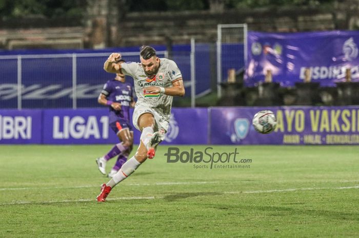 Striker Persija Jakarta, Marko Simic (jersey putih), sedang menendang bola dalam laga pekan ke-21 Liga 1 2021 di Stadion Gelora Ngurah Rai, Bali, 26 Januari 2022.