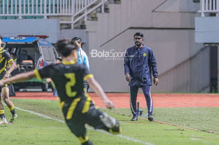 Pelatih timnas U-17 Malaysia, Osmera Bin Omaro (kanan), tampak sedang memantau para pemainnya bertanding dalam laga Kualifikasi Piala Asia U-17 2023 di Stadion Pakansari, Bogor, Jawa Barat, 9 Oktober 2022.