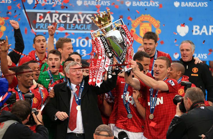 Manchester United manager Sir Alex Ferguson celebrates with the Premier League trophy