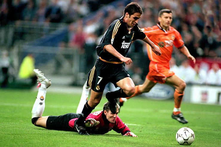 Real Madrid's Raul (c) scores the third goal of the game as Valencia goalkeeper Santiago Canizares (