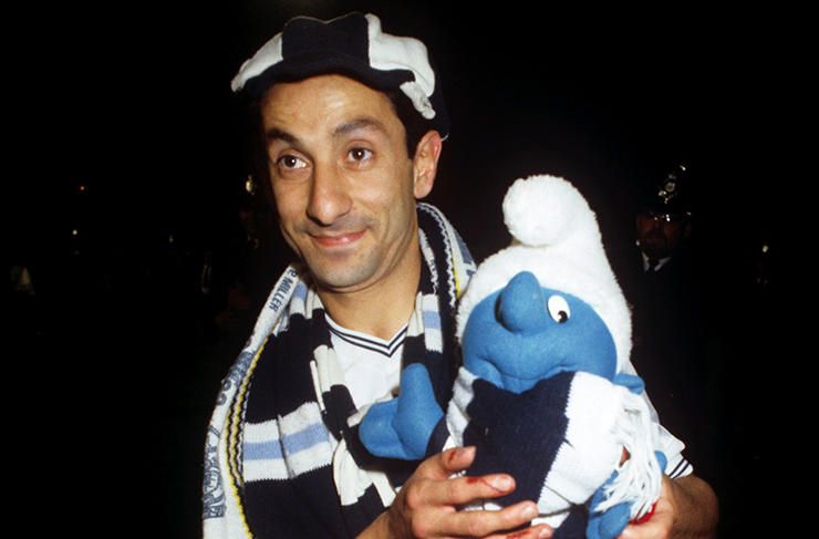 Ossie Ardiles celebrates with a toy smurf after Spurs win in the UEFA Cup against Anderlecht