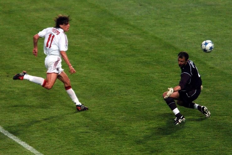 AC Milan's Hernan Crespo chips the ball past Liverpool's goalkeeper Jerzy Dudek to score the third g