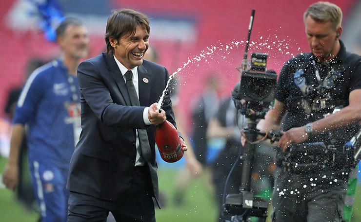 Chelsea manager Antonio Conte celebrates with champagne after the game