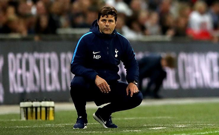Tottenham Hotspur manager Mauricio Pochettino crouches on the touchline during the Premier League ma