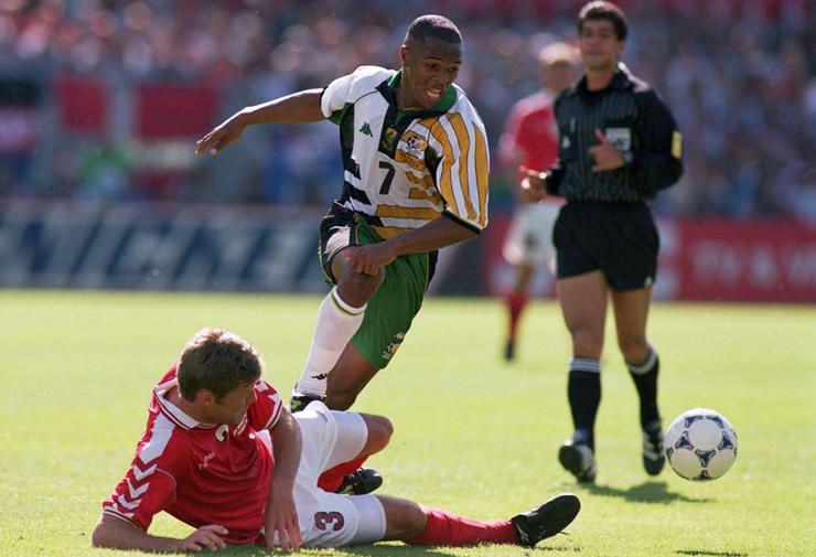 South Africa's Quinton Fortune (centre) is tackled by Denmark's Marc Rieper (on floor)