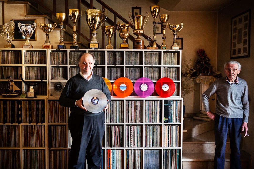 Alessandro Benedetti -  Monsummano Terme, ItalyAlessandro holds the Guinness World Record for largest collection of colored vinyl records. Pictured here at home with his father Marinello, Alessandro is holding a mirrored vinyl copy of Ozzy Osbourne’s Bark at the Moon. Above the duo are trophies that Alessandro won playing Subbuteo, a miniature football game.