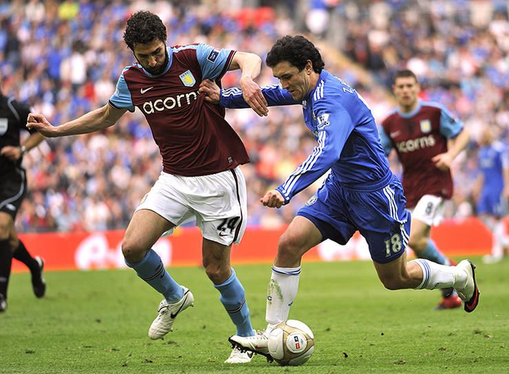 Chelsea's Yuri Zhirkov and Aston Villa's Carlos Cuellar (left) battle for the ball