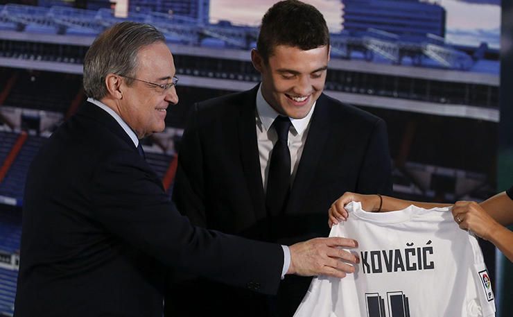 Croatian midfielder Mateo Kovacic (R) poses next to Real Madrid's president Florentino Perez, during