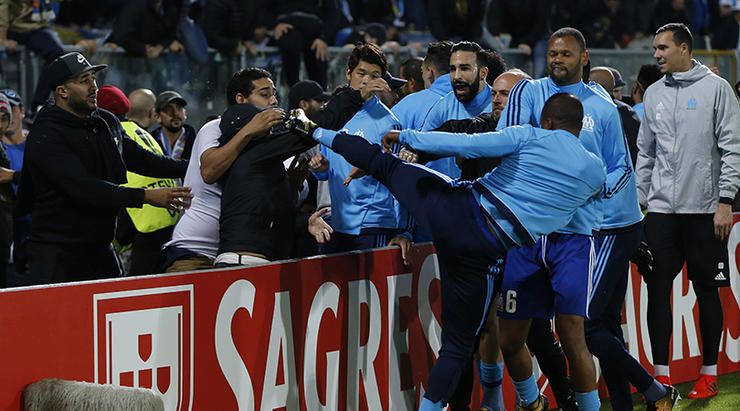 Patrice Evra sent off before game begins for kicking out at Marseille supporter