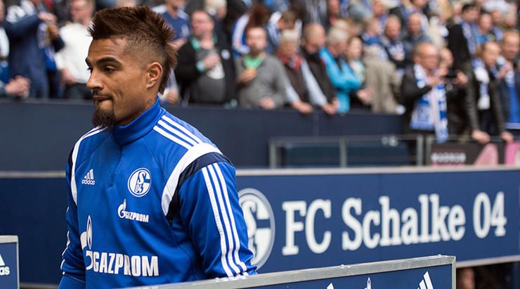 Schalke's Kevin-Prince Boateng takes his seat on the bench prior to the German Bundesliga soccer mat