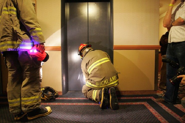Rescue workers from the Ottawa Fire Department work to free 16 people trapped in an elevator between the second and third floors of the Capital Hill Hotel and Suites in Ottawa, Ontario on January 18, 2007.  The elevator had become stuck due to overcrowding.