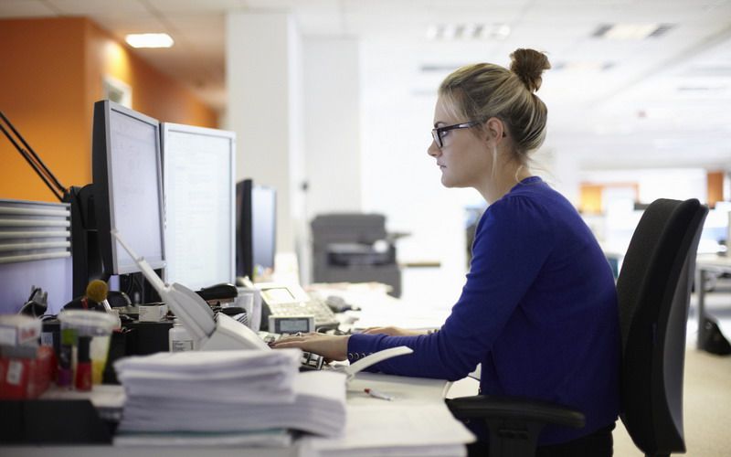 Young woman using computer in office