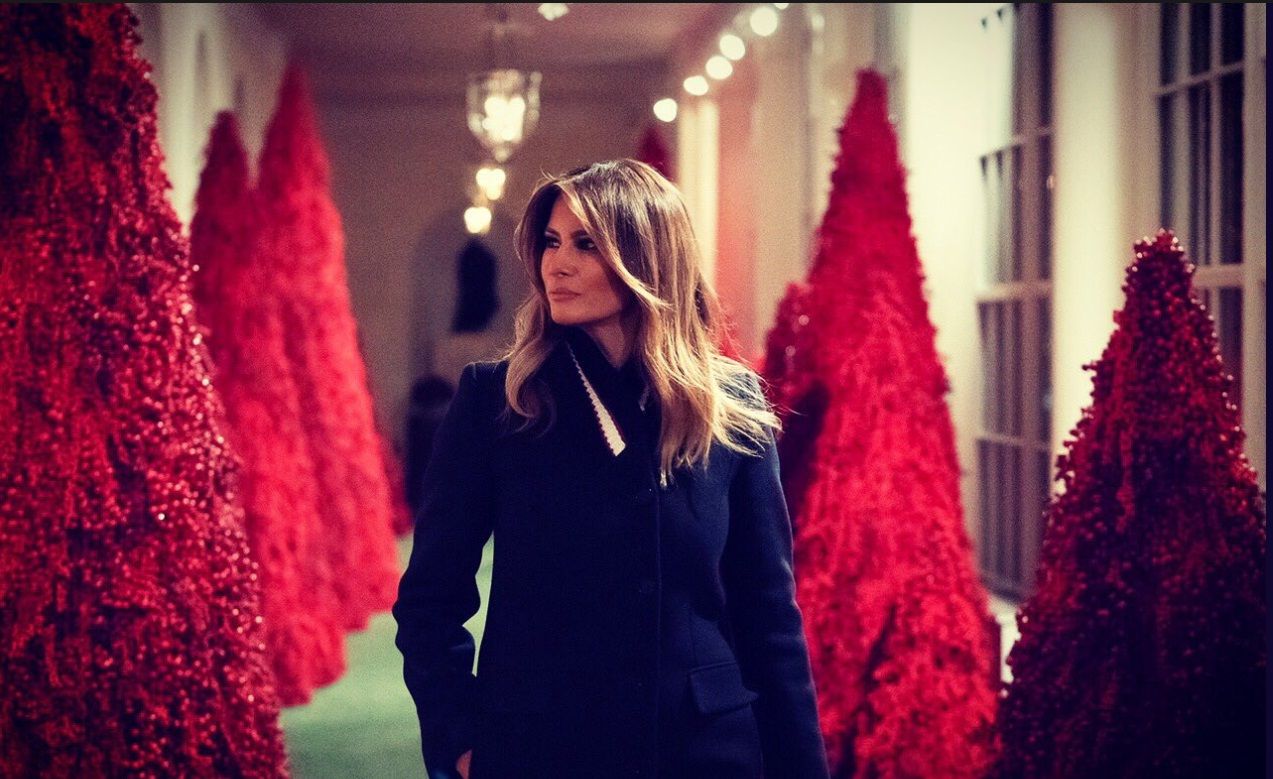 Melania Trump di tengah pohon-pohon Natal Gedung Putih rancangannya.