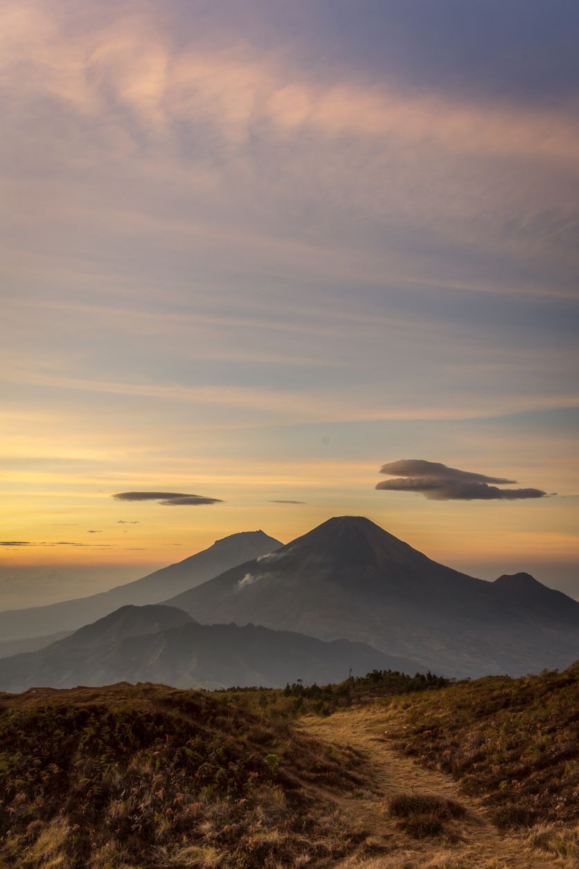Golden sunrise at Prau Mountain with Sindoro and Sumbing mountain on the background