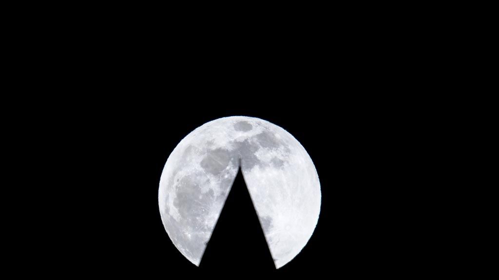 Siluet bagian puncak Monumen Washington dengan latar belakang gerhana bulan istimewa, Super Blood Wolf Moon, Minggu (20/1/2019).