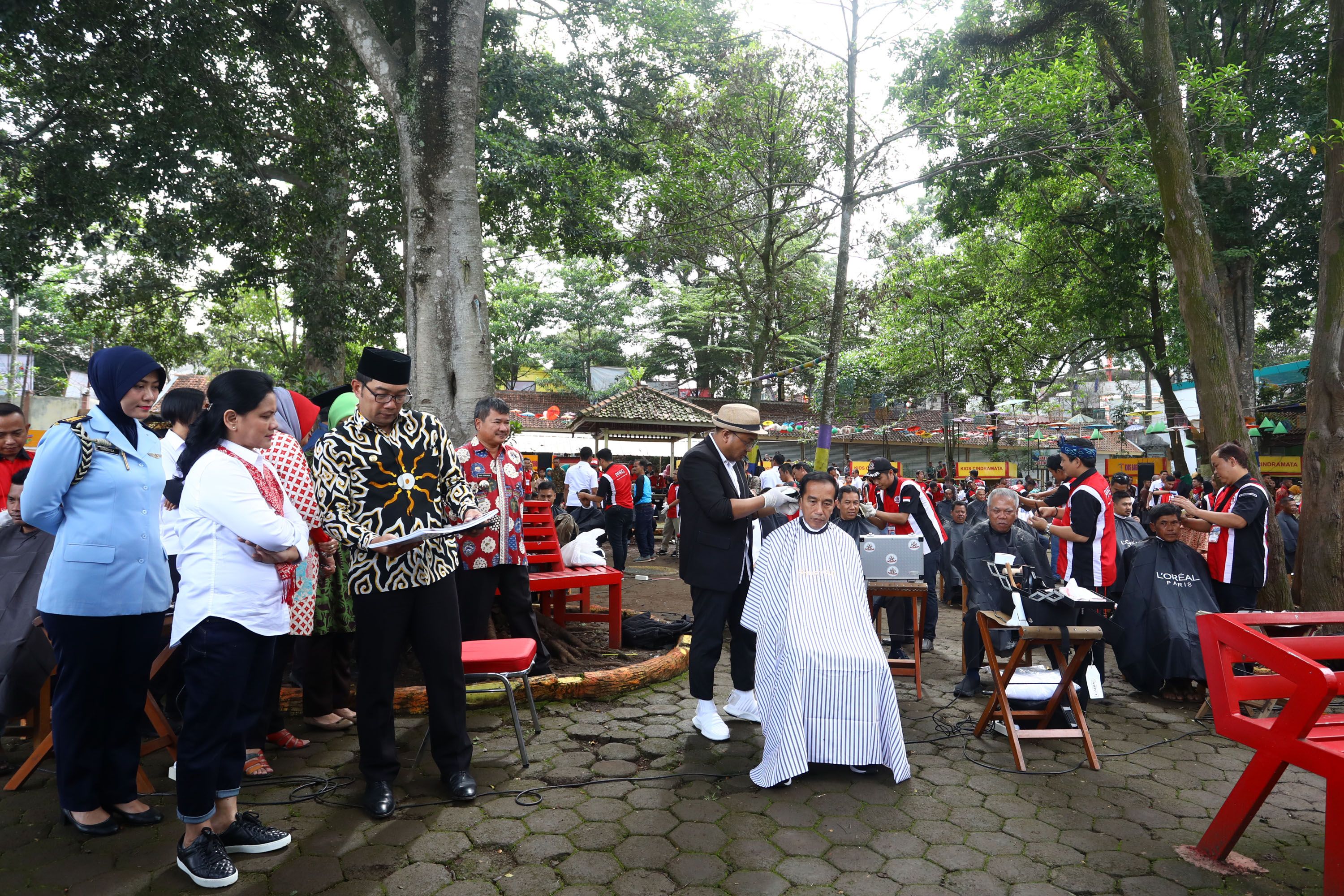 Presiden Joko Widodo (tengah) didampingi Ibu Negara Iriana Joko Widodo (kiri) mengikuti potong rambu