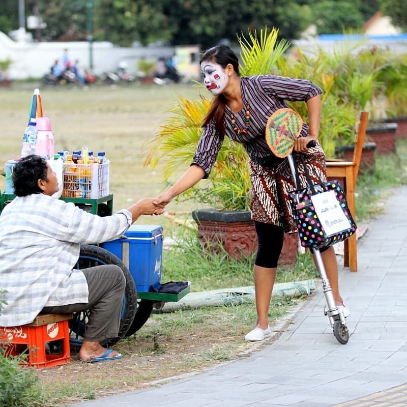 Inem Jogja saat sedang membantu pedagang kecil