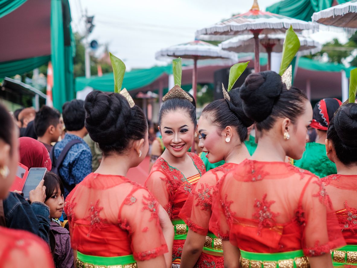 Yogyakarta, Indonesia - November 20 2015: A face of an Indonesian girl dance performer in the crowd who is conversing with her ground as they await for the performance to begin