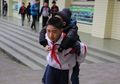 Patut Dicontoh, Seorang Bocah Dengan Setia Menggendong Sahabatnya yang Tidak Bisa Berjalan Setiap Hari