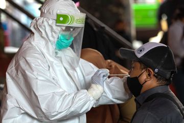 Petugas medis melakukan swab test Covid-19.