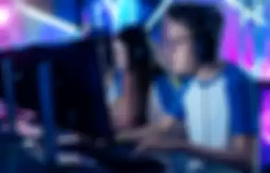 Team of Professional Cybersport Gamers Playing Video Games on a Cyber Games Tournament. Girls and Boys Have Headphones On, Arena is Lit with Neon Lights.