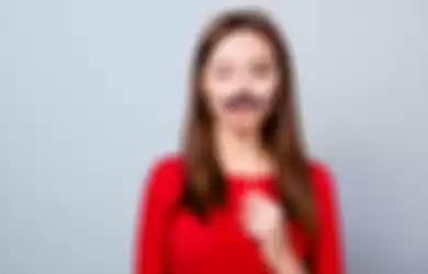 10 Ciri-Ciri Perempuan dengan Libido Tinggi, Salah Satunya Memiliki Kumis Tipisstanding over gray background