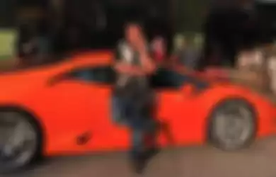 Hotman Paris mejeng di samping supercar Lamborghini yang dikemudikan Sunarto. 