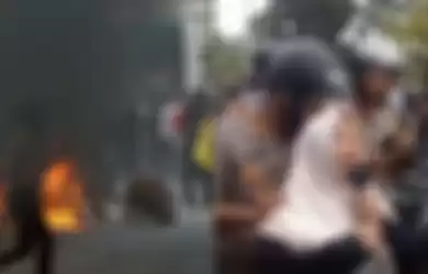 Seorang ibu bernama Suciati Emas, menangis mencari keberadaan anaknya diantara kerumunan pelajar yang berdemo di Gedung DPR RI