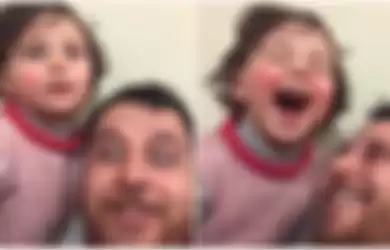 Ayah Ini Ajarkan Anaknya untuk Tertawa Saat Dengar Ledakan Bom