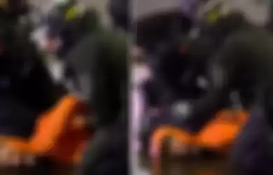 Polisi Seattle berusaha memindahkan lutut rekannya dari leher pelaku penjarahan.