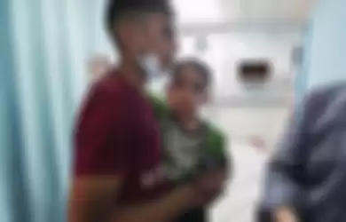 Foto pilu anak-anak Palestina. Reaksi seorang anak yang tampak trauma ketika ditenangkan oleh pemuda Palestina di Rumah Sakit al-Shifa usai serangan udara Israel menghantam Kota Gaza. Pemkot Padang memberikan bantuan ambulans untuk Palestina.