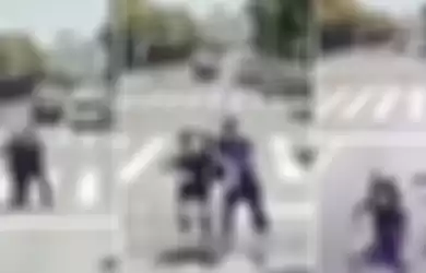 Potongan gambar dari video di dalam bus memperlihatkan seorang pria mendorong pacarnya ke arah bus yang sedang melintas saat mereka bertengkar di jalanan.