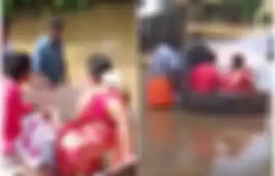 Pasangan di India naik panci karena banjir.