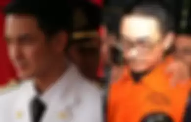 Mantan Gubernur Jambi Zumi Zola menggunakan rompi oranye usai menjalani pemeriksaan di Gedung KPK, Jakarta, Senin (9/4/2018)