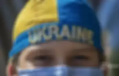 Seorang anak laki-laki Ukraina terlihat selama protes untuk mendukung Ukraina di depan Kedutaan Besar Rusia di Santiago, pada 24 Februari 2022