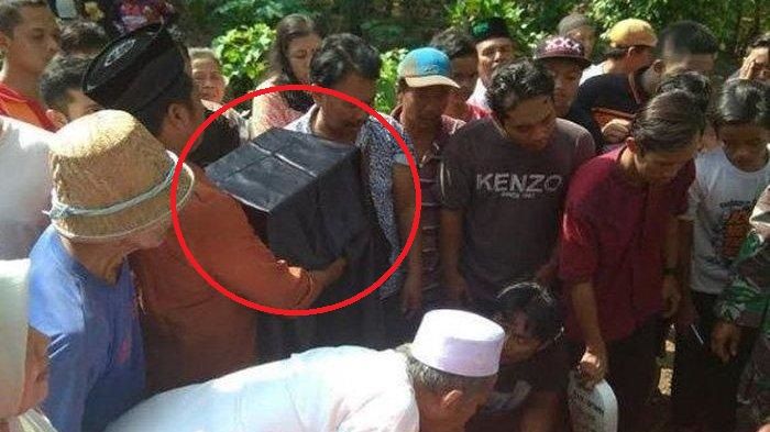 Potongan kepala Budi Hartanto (lingkaran merah) ketika akan disatukan dengan badannya di liang lahat