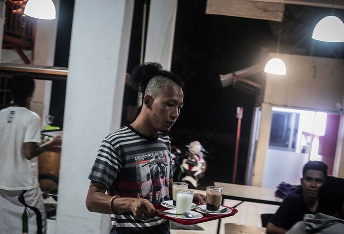 Foto dirilis Selasa (21/5/2019), menunjukkan seorang anak punk melayani pembeli di Kedai 'Kopi Shalawat' di Ciputat, Tangerang Selatan. Sebuah komunitas bernama Tasawuf Underground didirikan untuk merangkul dan mengenalkan kembali agama pada anak jalanan dan anak punk, serta membantu mengubah stigma