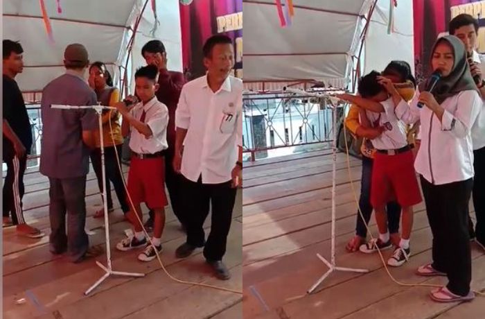 Seorang bocah SD yang menangis sesegukan saat menyayikan lagu untuk mendiang ayahnya.
