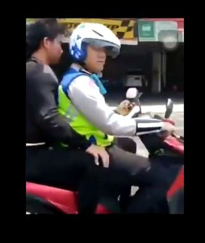 Polisi boncengi penumpang tanpa helm dan menggunakan ponsel saat berkendara