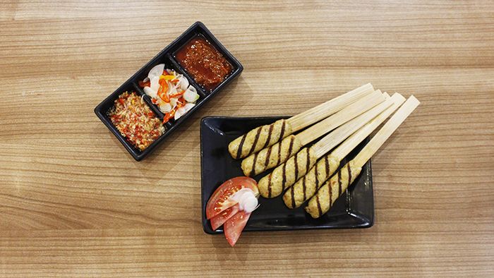 Warung Wardani's sate lilit (minced meat satay) features thick lamb meat immersed in a spices richness.