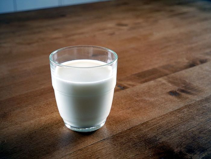 Ilustrasi segelas susu hangat untuk mengatasi gangguan tidur atau insomnia.