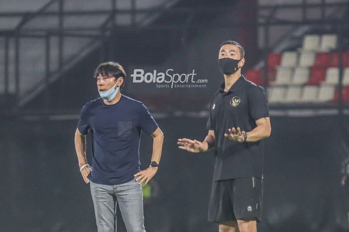 Pelatih timnas Indonesia, Shin Tae-yong (kiri), dan salah satu asistennya yakni Yoo Jae-hoon (kanan), sedang memberikan intruksi kepada para pemainnya  di Stadion Kapten I Wayan Dipta, Gianyar, Bali, 27 Januari 2022.