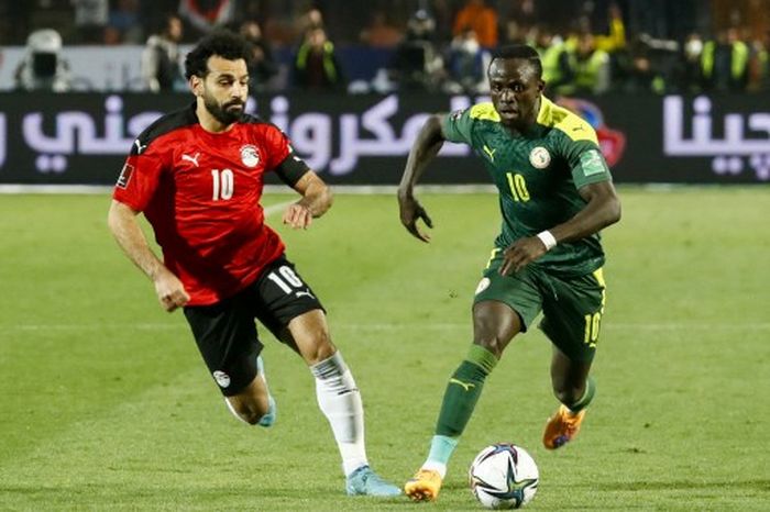 Mohamed Salah (kiri ) melawan Sadio Mane dalam duel kualifikasi Piala Dunia 2022 antara Mesir vs Senegal di Kairo (25/3/2022).