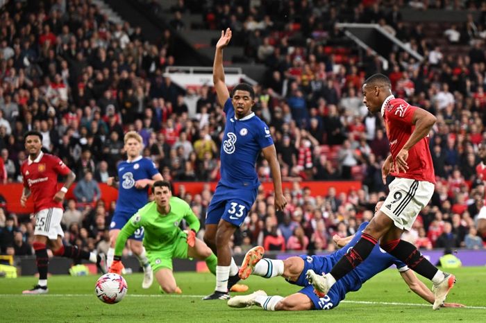 Manchester United's French striker Anthony Martial (R) shoots to score their second goal during the English Premier League football match between Manchester United and Chelsea at Old Trafford in Manchester, north west England, on May 25, 2023. (Photo by Oli SCARFF / AFP) / RESTRICTED TO EDITORIAL US
